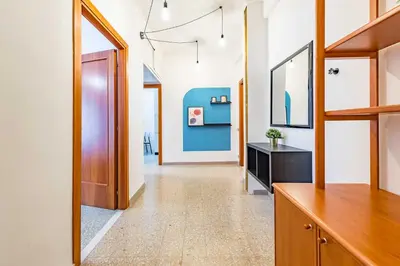 a living room with a blue couch and a table at Iolanda Fine & Spacious Flat in Rome