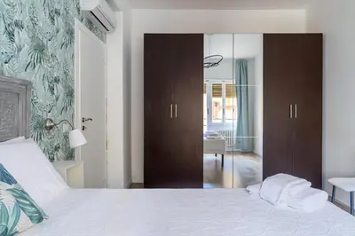 a bedroom with a bed and a sliding glass door at Domus Vatican View - San Pietro in Rome