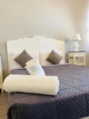 a hotel room with a bed with a towel on it at Blancmaisonteveresuite in Rome