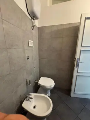 a bathroom with a toilet and a sink at Blancmaisonteveresuite in Rome