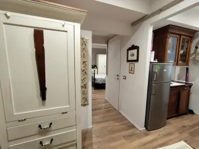a kitchen with a refrigerator and a hallway at Appartamento Suite Ponte Milvio in Rome