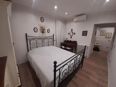 a bedroom with a bed and a desk in a room at Appartamento Suite Ponte Milvio in Rome