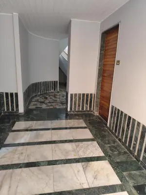 an empty hallway with white walls and a wooden door at Appartamento Suite Ponte Milvio in Rome
