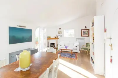 a living room with a table and a tv at Sales in Rome