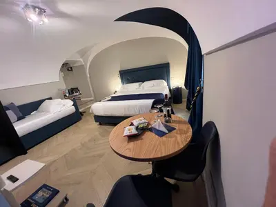 a hotel room with two beds and a table and a bed at Rome luxury blue suites- LOVE in Rome