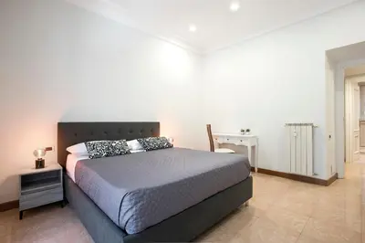 a bedroom with a large bed and a desk at Appia Luxe - A poche fermate del Centro in Rome