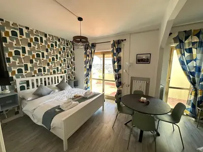 a bedroom with a bed and a table with chairs at Attico al Settimo Piano in Rome