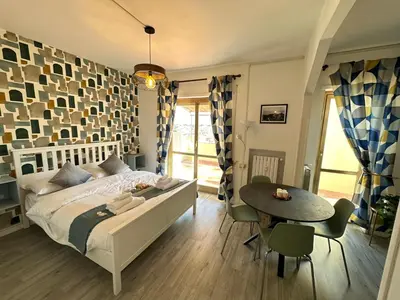 a bedroom with a bed and a table and chairs at Attico al Settimo Piano in Rome