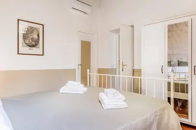 a white room with a bed with towels on it at Sweet home Trastevere- Roma in Rome