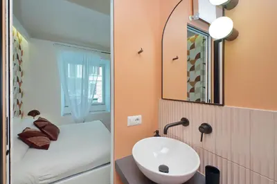 a bathroom with a sink and a mirror at YCH-Colorful and classy apartment near Fori Imperiali in Rome