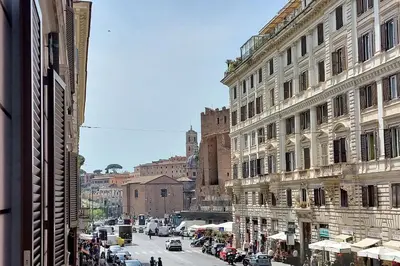 a busy city street with cars and people on the street at YCH-Colorful and classy apartment near Fori Imperiali in Rome