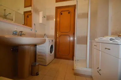 a bathroom with a sink and a washing machine at Casa Vacanze Zio Gionni in Rome