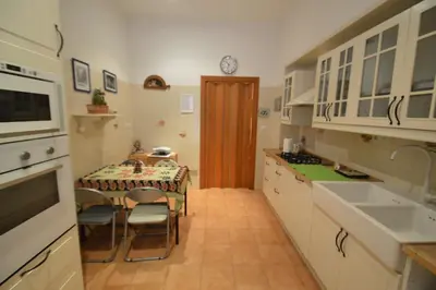 a kitchen with a table and a kitchen with a table and chairs at Casa Vacanze Zio Gionni in Rome