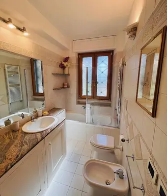 a bathroom with two sinks and a toilet and a tub at Vatican Terrace Apartment in Rome
