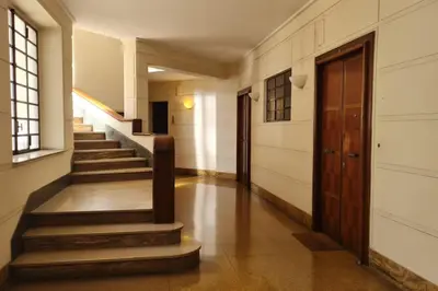 a hallway with stairs and a door in a building at RomeBestHome Beccaria - Piazza del Popolo in Rome