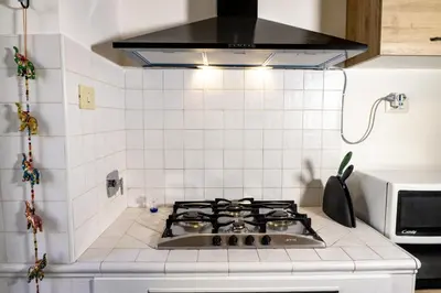 a kitchen with a stove top oven in a kitchen at Pamphili Rooms in Rome