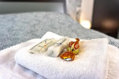 a couple of towels sitting on a bed at Pamphili Rooms in Rome