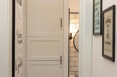 a hallway with a white door and a mirror at Khris Home Apartments - Trastevere Parini in Rome