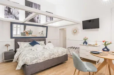 a bedroom with a bed and a table and a desk at Scipioni Vatican Studio distante 10 minuti a piedi dal Vaticano in Rome