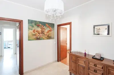 a room with a painting on the wall and a dresser at La Lanterna Di San Pietro in Rome