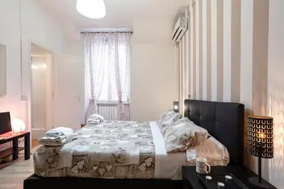 a bedroom with a bed and a window at Liberty House in Rome