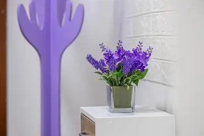 a vase of purple flowers sitting on a table at Dreamhome61 by Rentbeat in Rome