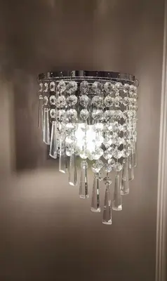 a chandelier with many wine glasses hanging from it at Miracol in Rome