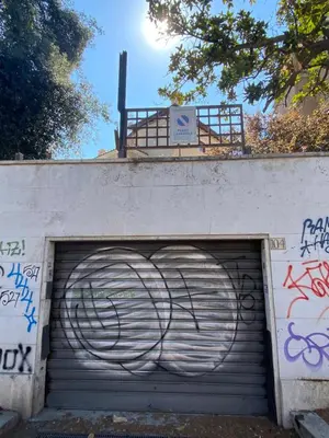 a garage with a garage door with graffiti on it at Under Trastevere stars in Rome