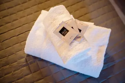 a white towel sitting on top of a bed at Appia Antica Country House giardino parcheggio Fermata bus in Rome
