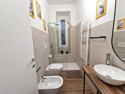 a white bathroom with a sink and a toilet at Varia Domus in Rome