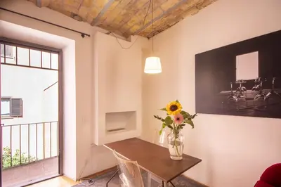 a dining room with a table and a vase of flowers at Scuderie San Lorenzo in Rome
