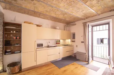 a kitchen with white cabinets and a large window at Scuderie San Lorenzo in Rome