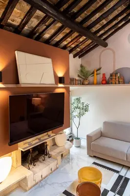 a living room with a large flat screen tv on a wall at Altiora - Luxury loft in Trastevere, Rome in Rome