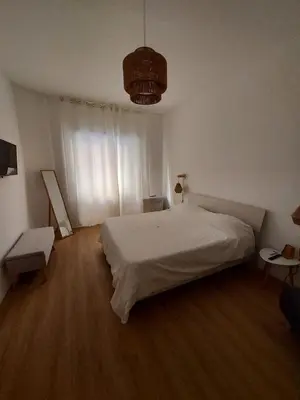 a bedroom with a white bed and a chair at Interno 4 al Vaticano in Rome