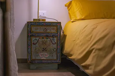 a bed with a colorful box next to a bed at Sciampagne in Rome