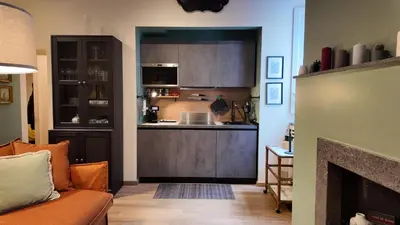 a living room with a couch and a kitchen at Sciampagne in Rome