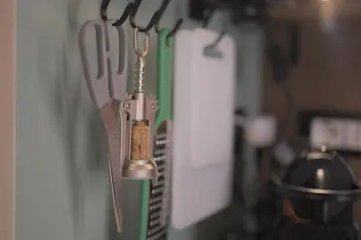 a bunch of knives hanging on a wall at Sciampagne in Rome