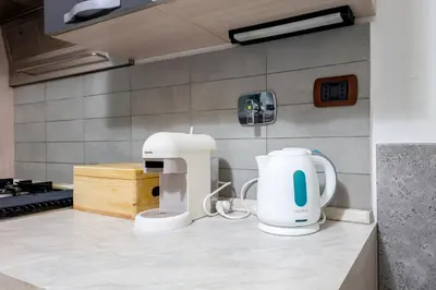 a kitchen with a coffee maker on a counter at HOME Suitte in San Giovanni near Basilica - Roma - in Rome
