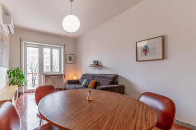 a living room with a wooden table and chairs at Casilina Green House - Metro Malatesta & Wi-Fi in Rome