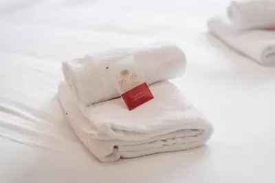 a pile of white towels sitting on a table at Casilina Green House - Metro Malatesta & Wi-Fi in Rome