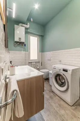a bathroom with a washing machine and a sink at Casilina Green House - Metro Malatesta & Wi-Fi in Rome