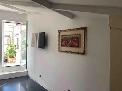 a room with a painting on a wall with a window at Vivi la Magia di Looney Tunes, piazza navona in Rome