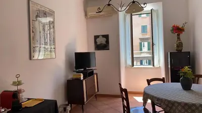 a living room with a table and a television at Colosseum home in Rome