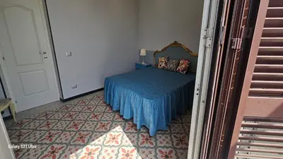 a bedroom with a bed with a blue bedspread at Vatican Roma Caput Mundi in Rome