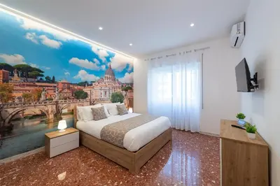 a bedroom with a bed and a painting of a city at Luxury and Sweet home-Metro Malatesta in Rome