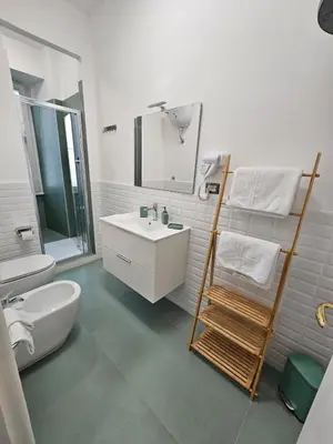 a bathroom with a sink and a toilet and a mirror at The Place Milizie in Rome