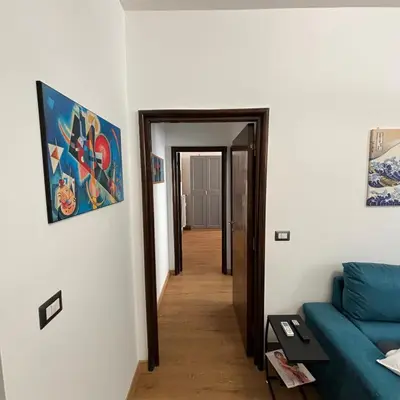 a hallway with a blue couch in a room at The Place Milizie in Rome