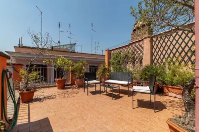 a patio with chairs and plants and a building at 2 BR Flat with Vatican Terrace in Rome