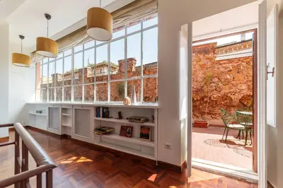 a room with a large window and a book shelf at 2 BR Flat with Vatican Terrace in Rome