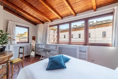 a bedroom with a bed and a large window at 2 BR Flat with Vatican Terrace in Rome